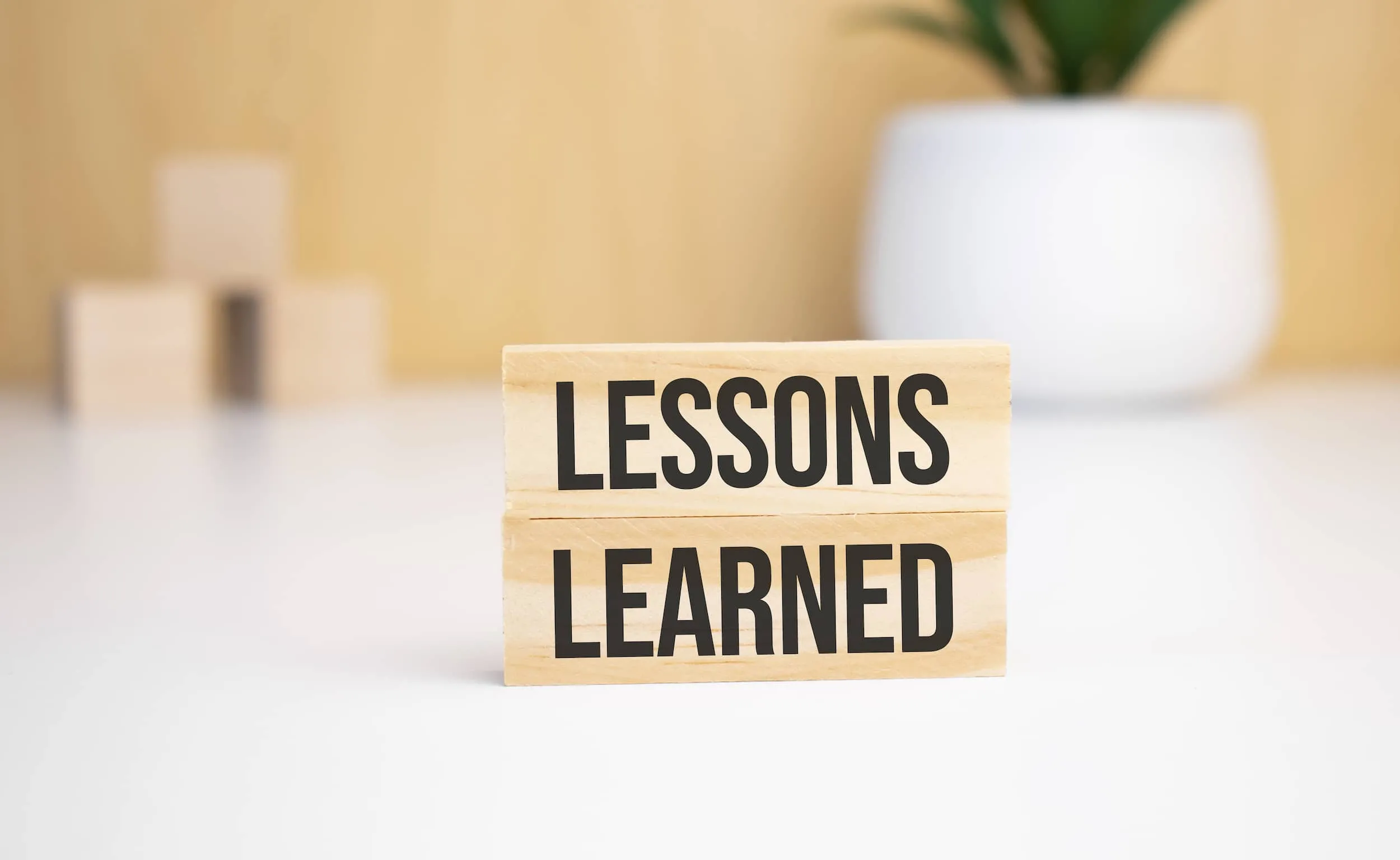 Two blocks stacked with the words Lessons Learned written on them